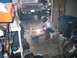 1984 Ford Bronco - Person welding a metal frame in a garage with a Ford Bronco and another truck visible.