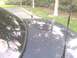 1997 Mercury Grand Marquis - The top of a dark car is visible, equipped with multiple antennas and a mounting base.