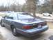 1997 Mercury Grand Marquis - This 1997 Mercury Grand Marquis is seen from the rear three-quarter angle, with another white car visible in the background.