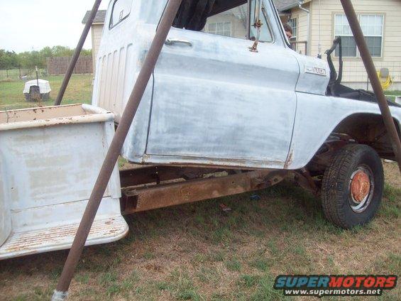 old pickup truck body on frame, being worked on outdoors