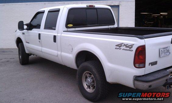 White 2002 Ford F-250 pickup truck, rear 3/4 view