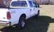 2002 Ford F-250 - White 2002 Ford F-250 pickup truck with 4x4 Off Road badging is viewed from the rear.