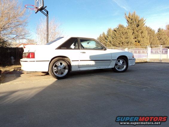 White 1989 Ford Mustang GT coupe parked on a driveway, side view