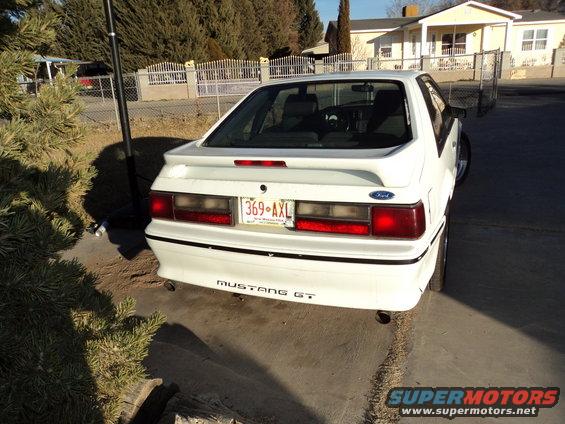 Rear view of a white 1989 Ford Mustang GT parked on a driveway