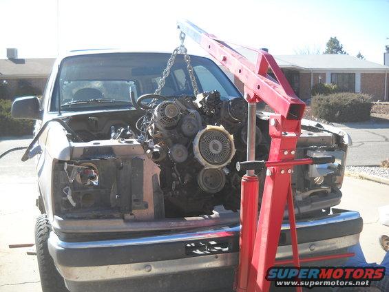 1992 Ford Explorer engine removal with red engine hoist, front view