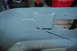 2010 Kawasaki BAYOU 220 - A close-up view of a gray, welded metal part with visible welds and cutouts.