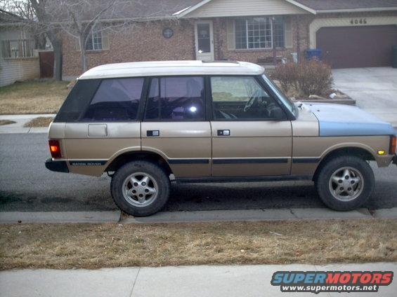 Side view of a 1991 Land Rover Range Rover parked on a residential street