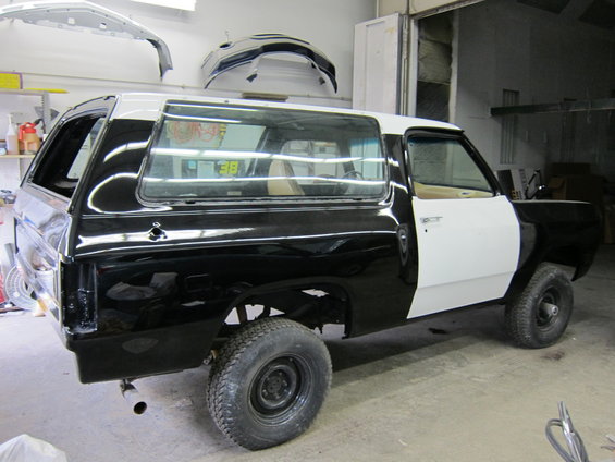 Dodge Ramcharger in black and white primer, undergoing bodywork. Interior is visible