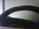 1996 Ford Bronco - A black fender flare is shown in a close-up, angled shot against a light-colored wall.