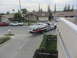 1964 Ford Ranchero - A white pickup truck is being towed on a flatbed truck down a suburban street.