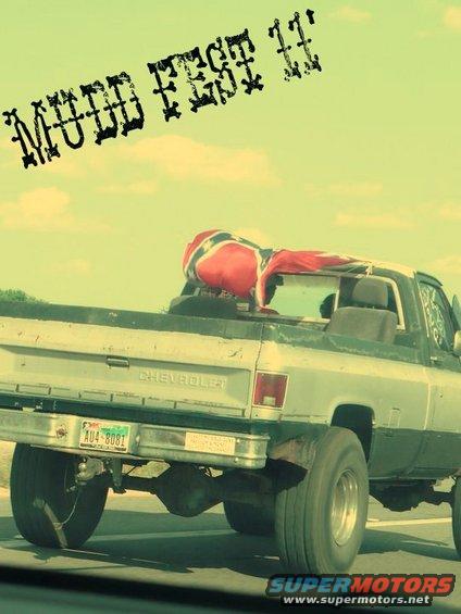 Rear view of a Chevrolet pickup truck with a Confederate flag over the cab. License plate reads AU4-8081