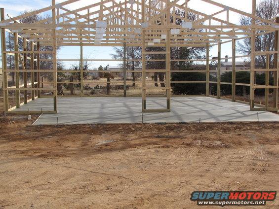 Under construction building with wooden frame and concrete floor