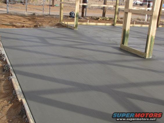fresh concrete slab with wooden forms for a building structure