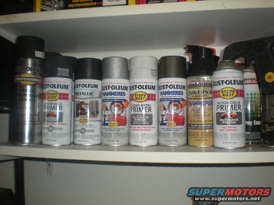 Various cans of Rust-Oleum spray paint and primer on a shelf