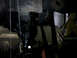 1996 Ford F-150 - A dimly lit view of a vehicle's undercarriage, showing mechanical parts and a tire.