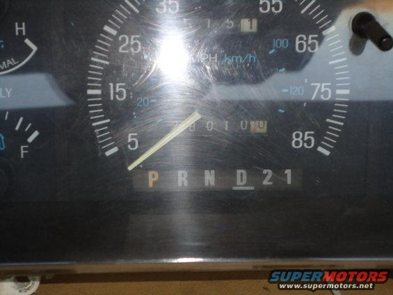 Close-up of a truck's dashboard gauges, showing the speedometer, odometer, and gear selector