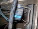 1991 Land Rover Range Rover - A close-up view of a vehicle's engine bay shows a blue electrical connector attached to a component.