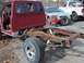1987 Ford Ranger - The frame and cab of a 1987 Ford Ranger are visible, with significant rust on the chassis.