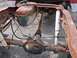 1987 Ford Ranger - The rear suspension and fuel tank assembly of a heavily rusted truck chassis is visible.