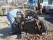 1987 Ford Ranger - A person works on the engine and chassis of a disassembled vehicle outdoors, with another vehicle body visible.