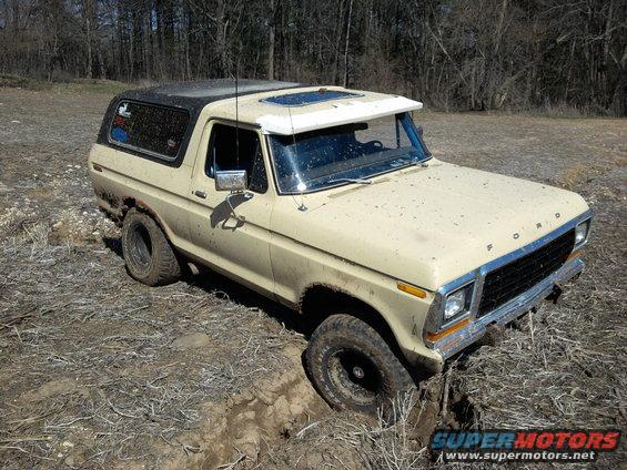 1978 Ford Bronco stuck in a muddy ditch off-road