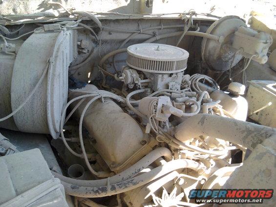 Engine bay covered in dust, showing carburetor and air filter