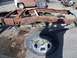 1987 Ford Ranger - This is a heavily rusted truck frame, not a complete vehicle. A tire is attached.