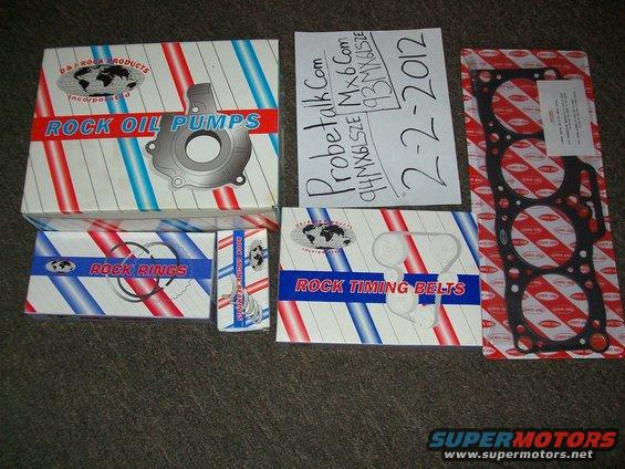 Boxes of Rock Oil Pumps, Rock Rings, and Rock Timing Belts, plus a gasket and a handwritten note about a 93/94 Mazda MX6
