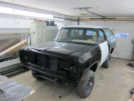 Black and white 1987 Dodge Ramcharger in garage, front end disassembled