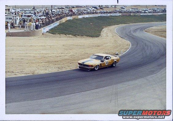 Yellow 1970 race car with number 16 on door on track