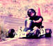 1976 Yamaha XS650 - A go-kart with the number 75 prominently displayed on its side is driven by a person wearing a helmet.