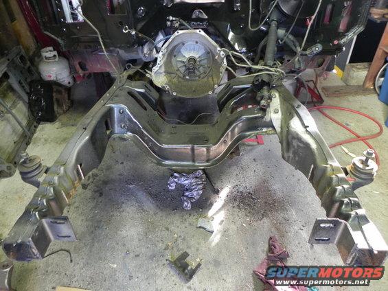 Vehicle frame with engine and transmission removed, showing the chassis