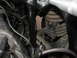 1964 Ford Ranchero - Close-up view of engine bay bracing and suspension components, showing a black metal brace and a coil spring.