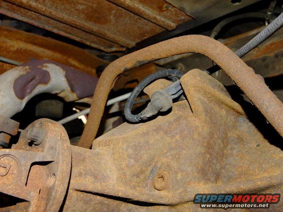 close-up of rusty rear differential and exhaust pipe on a vehicle