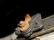 1995 Ford Bronco - Close-up view of a rusted metal bracket with a bolt and nut, likely part of a vehicle's chassis.