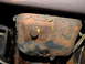 1995 Ford Bronco - The underside of a vehicle shows significant rust on the oil pan and surrounding components.