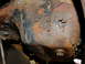 1995 Ford Bronco - Close-up of a corroded metal component, likely from a vehicle's undercarriage.