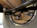 1995 Ford Bronco - Rusty rear suspension leaf spring and brake drum assembly, likely from an older vehicle.