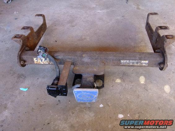 Ford trailer hitch receiver with wiring harness and blue Ford emblem