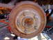 1995 Ford Bronco - Rusty brake drum and suspension components, likely from an older vehicle undergoing maintenance.