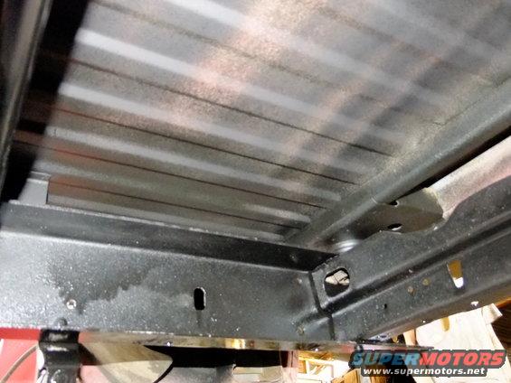 Underside chassis with ribbed metal bed and black frame