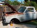 1960 Ford Ranchero - This 1960 Ford Ranchero is in rough condition, with rust and primer visible, and the hood is propped open.