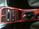 1995 Ford Probe - A close-up view of a car's interior dashboard, a red trim around the radio and climate controls.