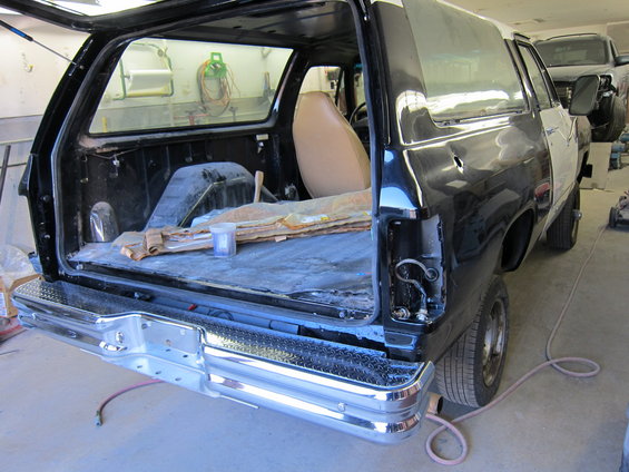 Black SUV interior and rear, undergoing repairs