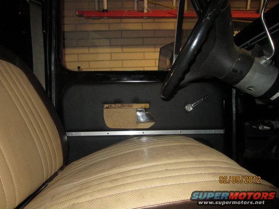 Passenger seat and door panel of a vehicle, with steering wheel visible. Date stamp shows 02/09/2012