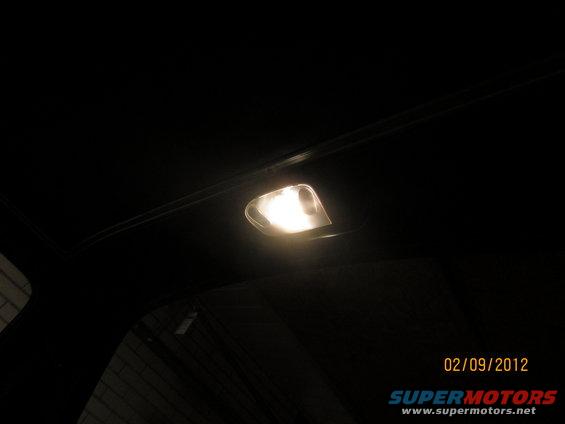 Interior dome light illuminated in a dark vehicle cabin