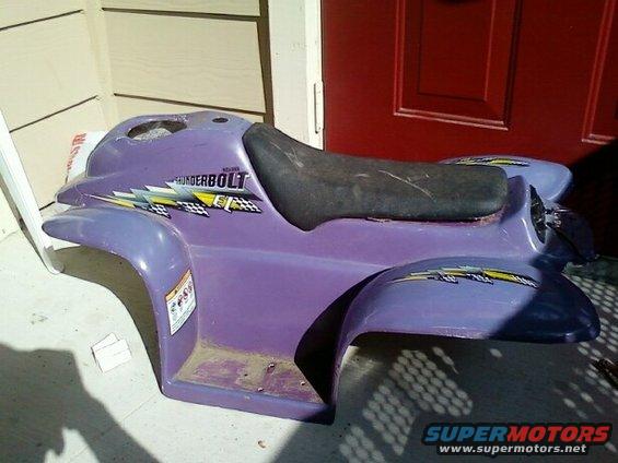 Purple ATV body panel with 'THUNDERBOLT' decal and checkered flags