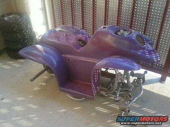 Purple ATV body with exposed frame and wheels