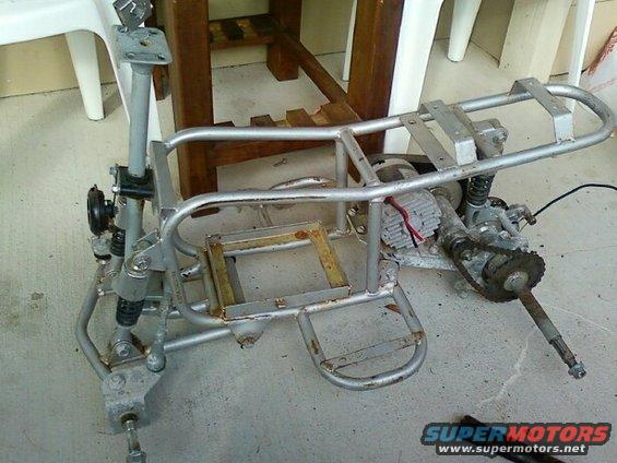 ATV frame with motor, chain drive, and suspension components