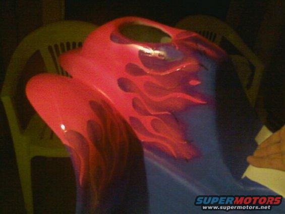 Red and blue custom painted car part with flame graphics